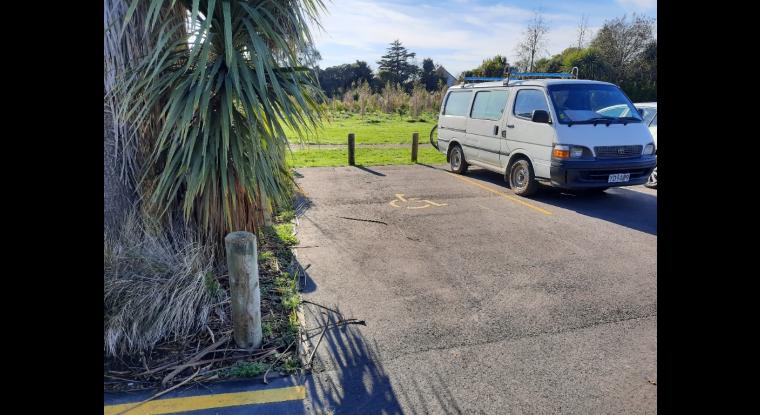 A wide accessible park directly next to an entry/exit point.