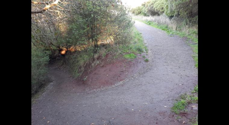 Tight steep corner. Loose gravel at top end.